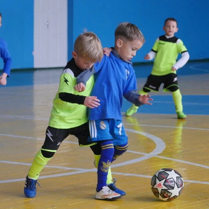 Young children playing in an indoor soccer competition